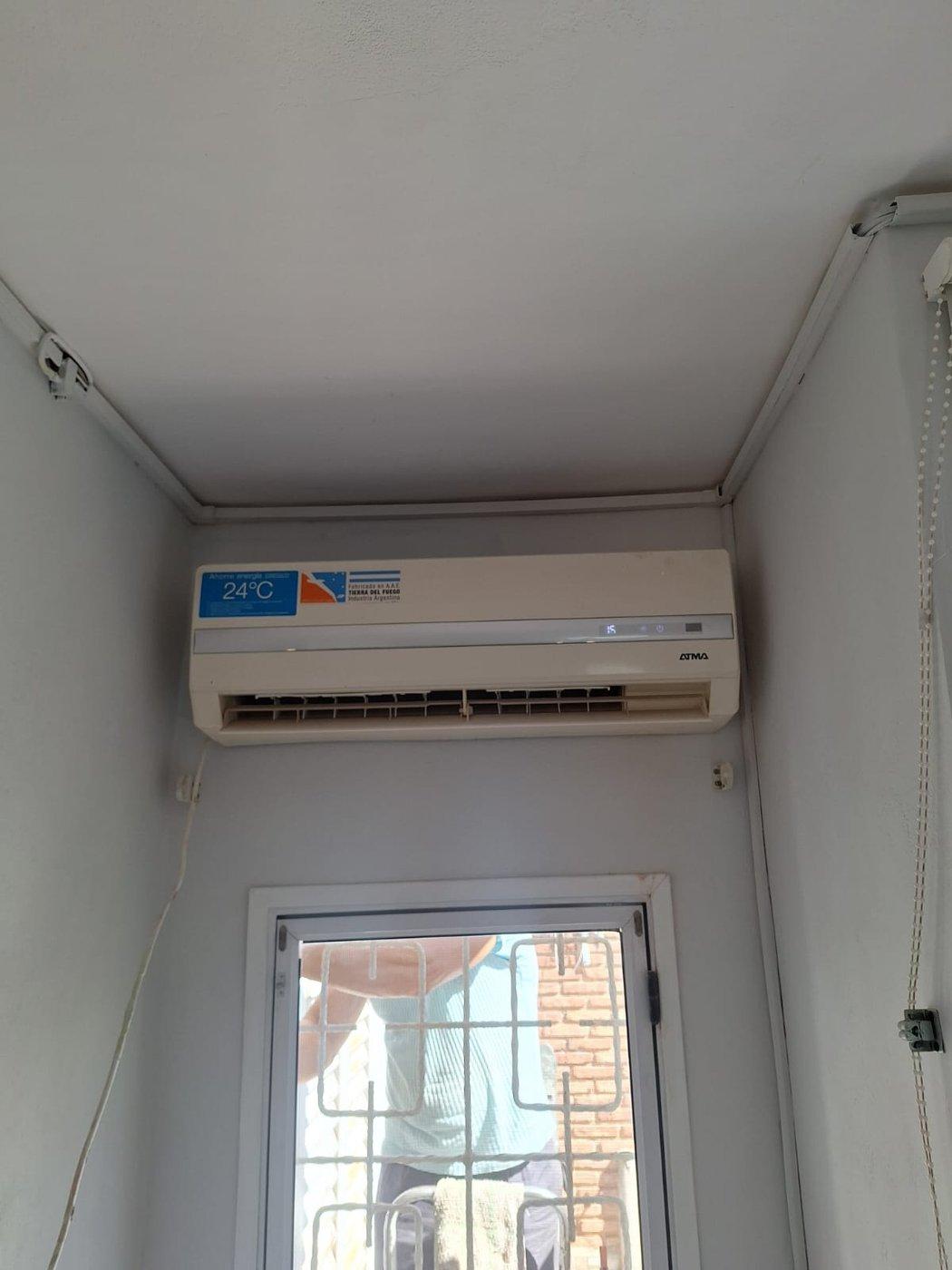 Equipo de aire acondicionado split instalado en la parte alta de una pared